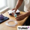 Caregiver setting up a disposable nebulizer replacement kit beside a compatible compressor.