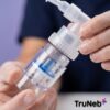 Close-up of disposable nebulizer medication cup, T-piece and connection details.