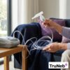 Flexible kink-resistant nebulizer tubing arranged beside a compatible compressor.